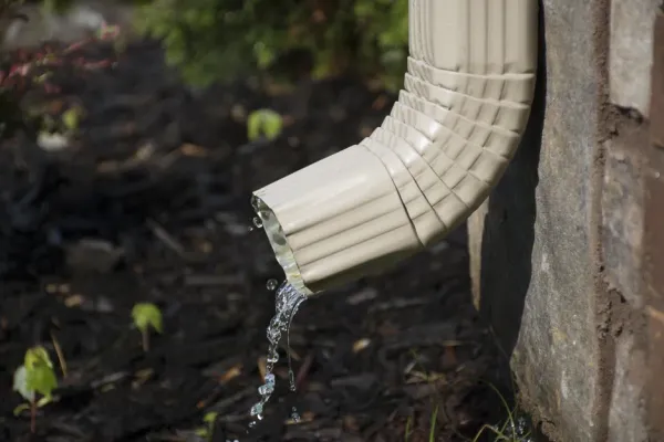 Downspout clearing and inspection before the next storm